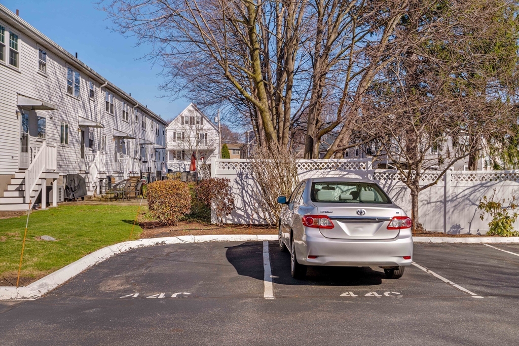 44 Salem Street, Unit C Wakefield, MA 01880 - Photo 25 of 26 a car parked in front of a brick house
