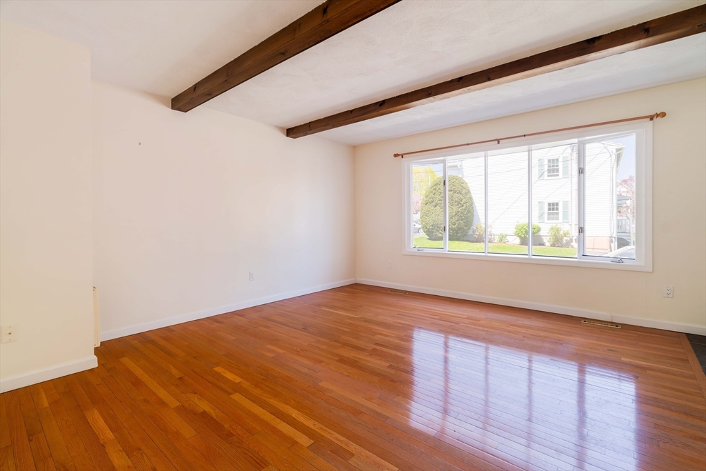 44 Salem Street, Unit C Wakefield, MA 01880 - Photo 4 of 26 a view of an empty room with wooden floor and a window