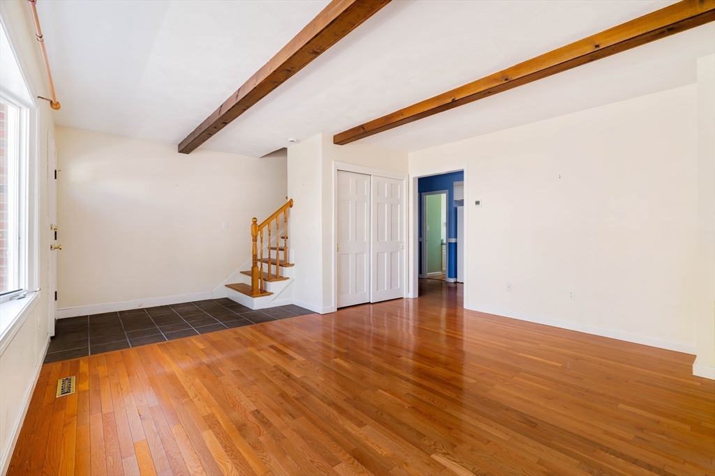 44 Salem Street, Unit C Wakefield, MA 01880 - Photo 6 of 26 a view of an empty room with wooden floor and a window