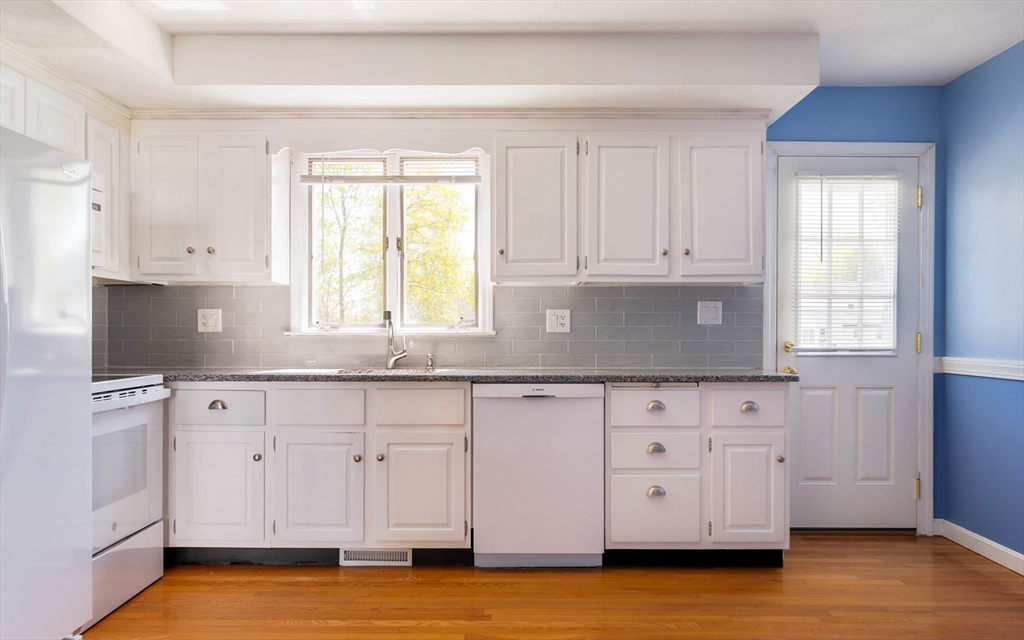 44 Salem Street, Unit C Wakefield, MA 01880 - Photo 7 of 26 a kitchen with granite countertop white cabinets white stainless steel appliances and a window