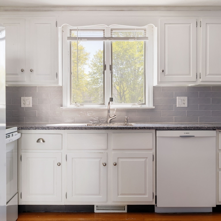 44 Salem Street, Unit C Wakefield, MA 01880 - Photo 9 of 26 a kitchen with granite countertop white cabinets and a window