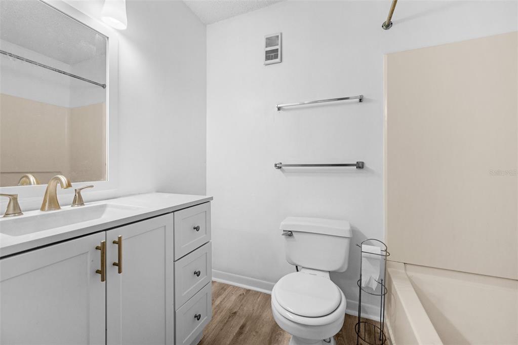 3921 Southwest 34th Street, Unit 208 Gainesville, FL 32608 - Photo 17 of 33 a bathroom with a toilet sink vanity and mirror