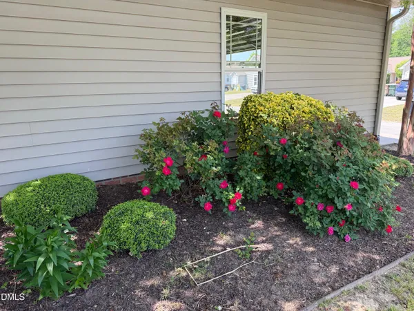 a view of a house with a yard and sitting area
