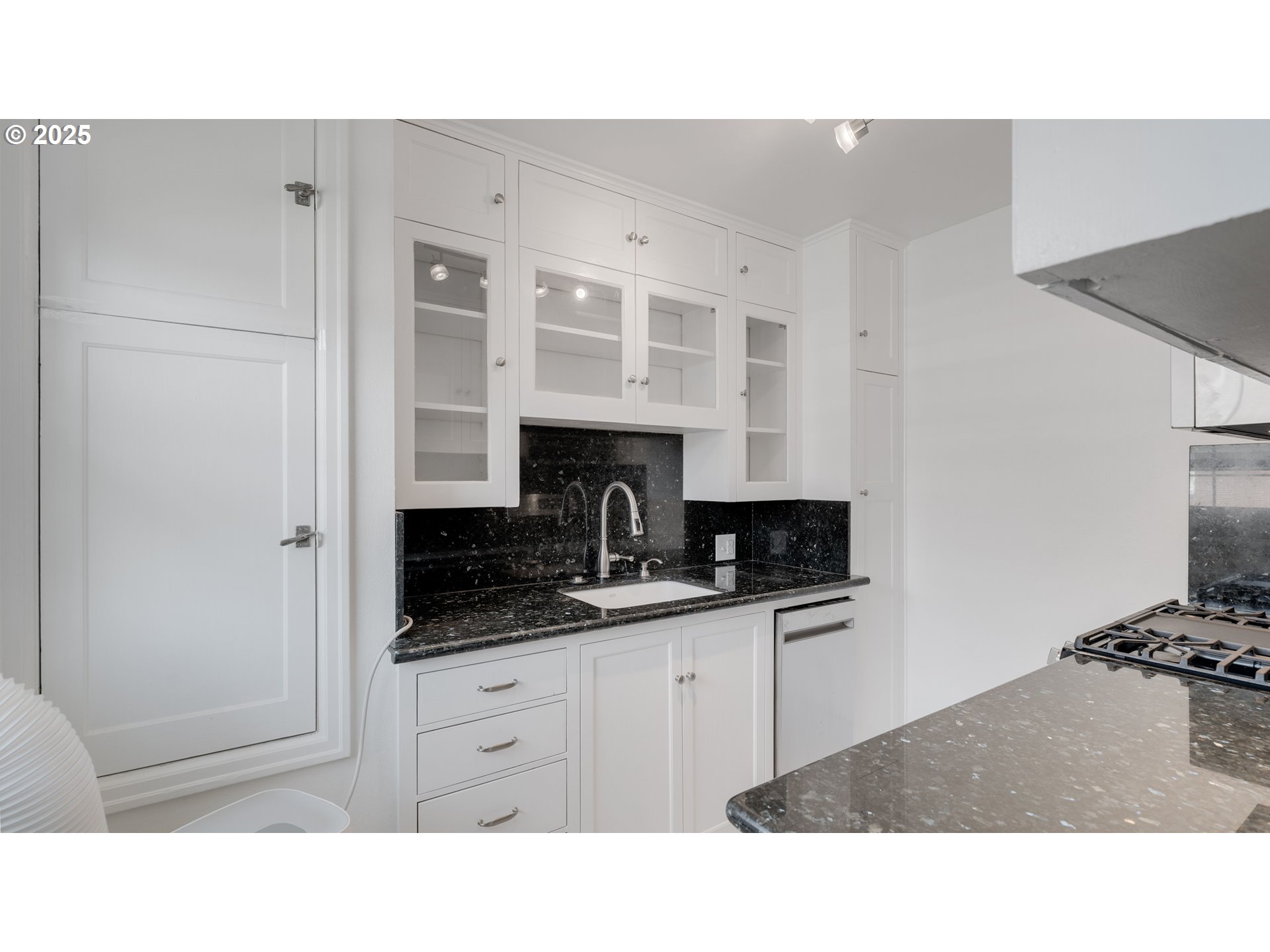308 East 12th Street, Unit 308B Vancouver, WA 98660 - Photo 11 of 28 a kitchen with granite countertop a sink stainless steel appliances and cabinets