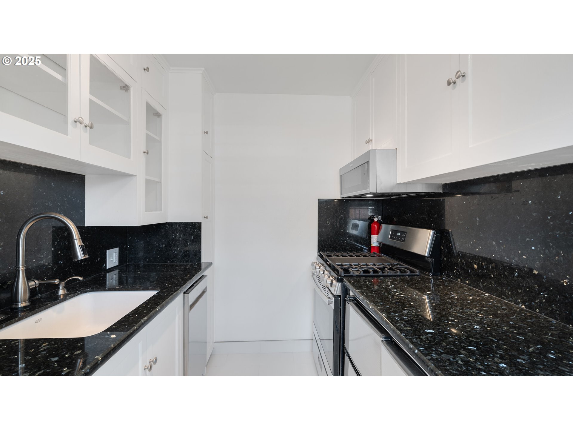 308 East 12th Street, Unit 308B Vancouver, WA 98660 - Photo 12 of 28 a kitchen with a sink a stove and cabinets
