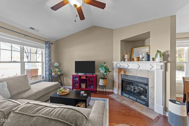 a living room with furniture a flat screen tv and a fireplace