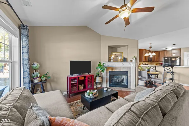 a living room with furniture a fireplace and a flat screen tv