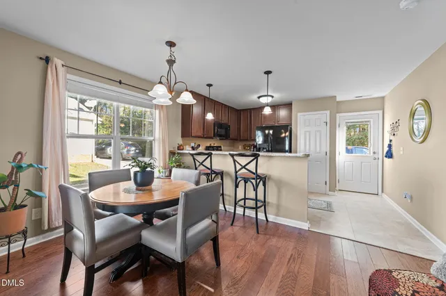 a view of a dining room with furniture window and wooden floor