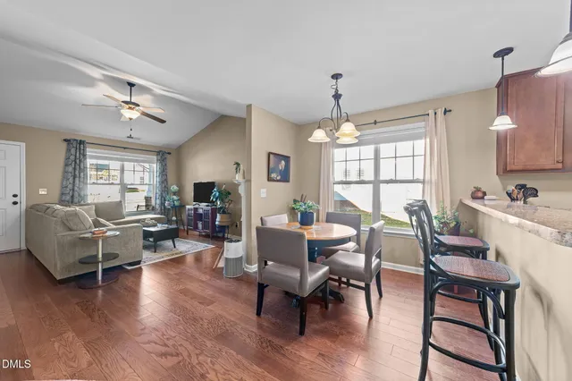 a living room with furniture dining table and a window