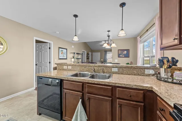 a kitchen with a sink a counter space appliances and cabinets