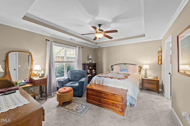 a bedroom with bed couch and window