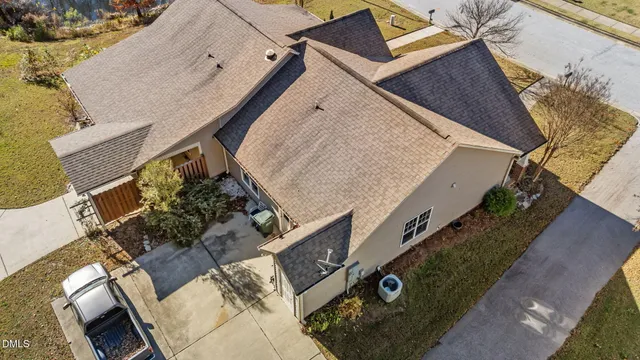 an aerial view of a house with a yard