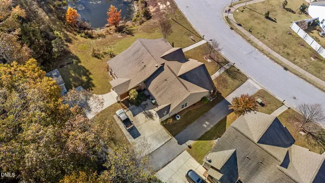 an aerial view of a house with a yard