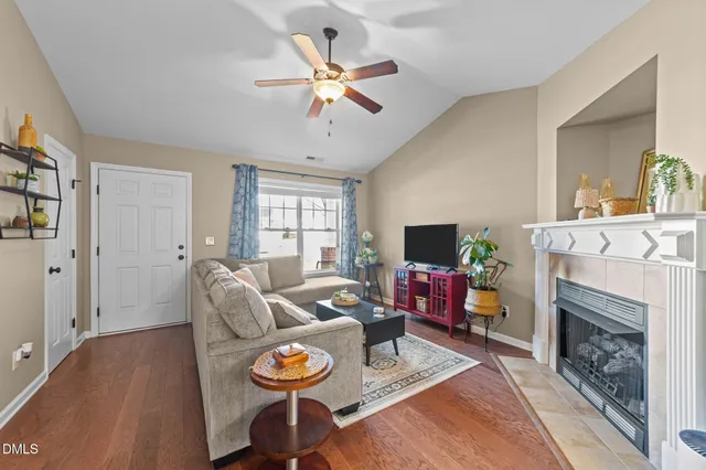 a living room with furniture a fireplace and a flat screen tv