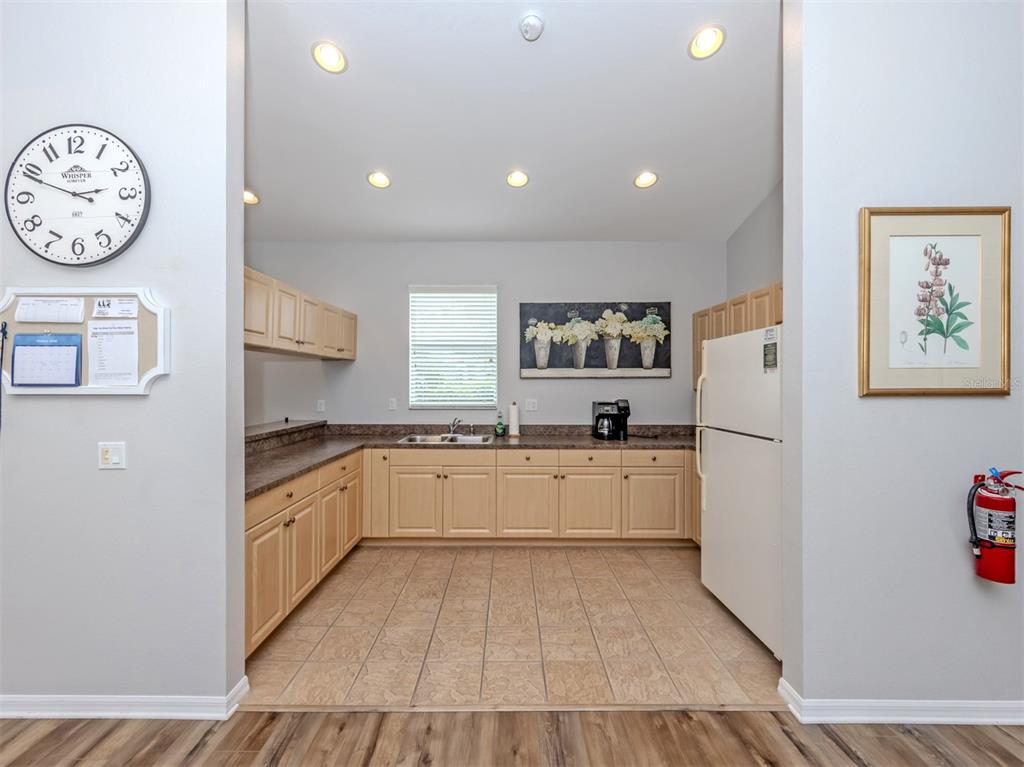 205 Reclinata Circle Venice, FL 34292 - Photo 38 of 62 a large kitchen with stainless steel appliances granite countertop a stove and a refrigerator