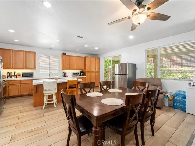 a view of a dining room and livingroom with furniture window and wooden floor