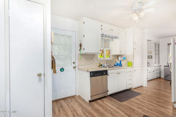 a kitchen with stainless steel appliances a stove refrigerator a sink and wooden floor