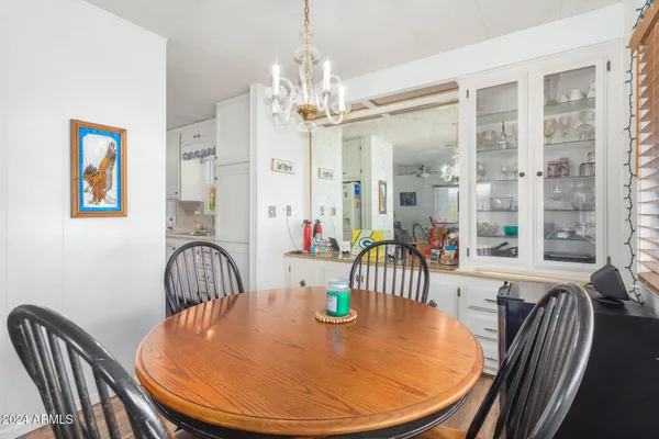 a view of a dining room with furniture wooden floor and chandelier