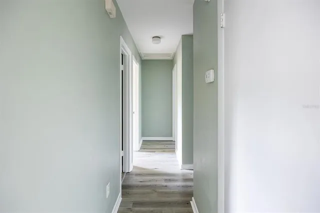 an empty room with a window and a ceiling fan