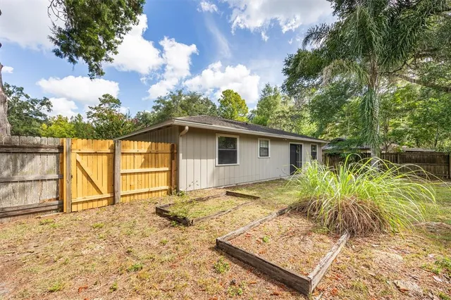 a front view of a house with a yard garage and outdoor seating
