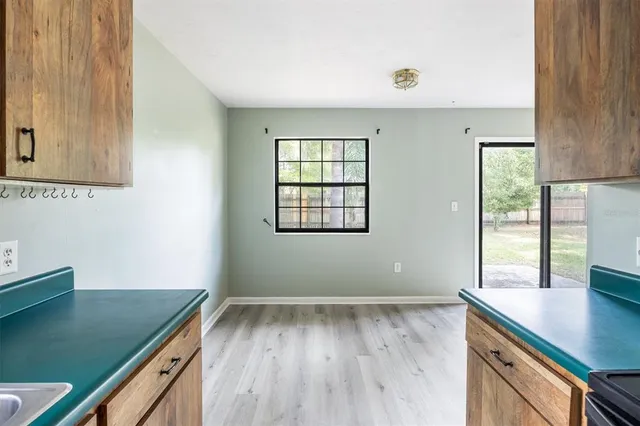 a view of kitchen with wooden floor and fan