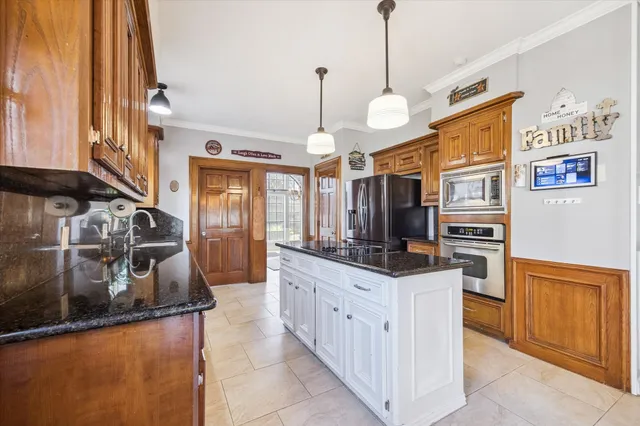 a kitchen with stainless steel appliances granite countertop a sink and a stove
