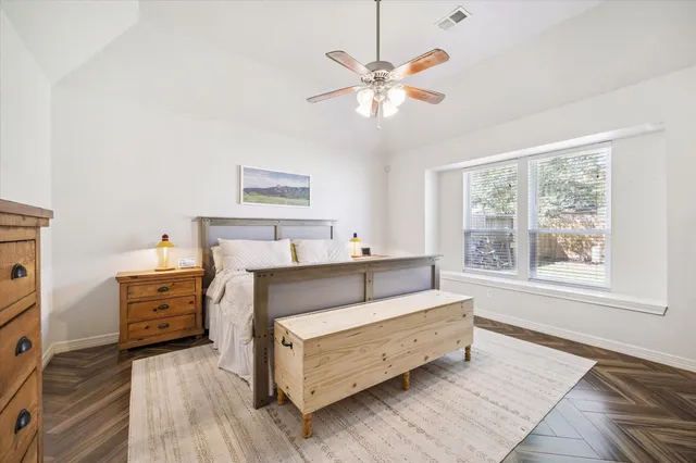 a bedroom with a bed and a chandelier