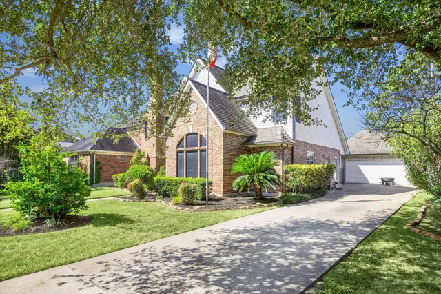 a front view of a house with a yard and potted plants