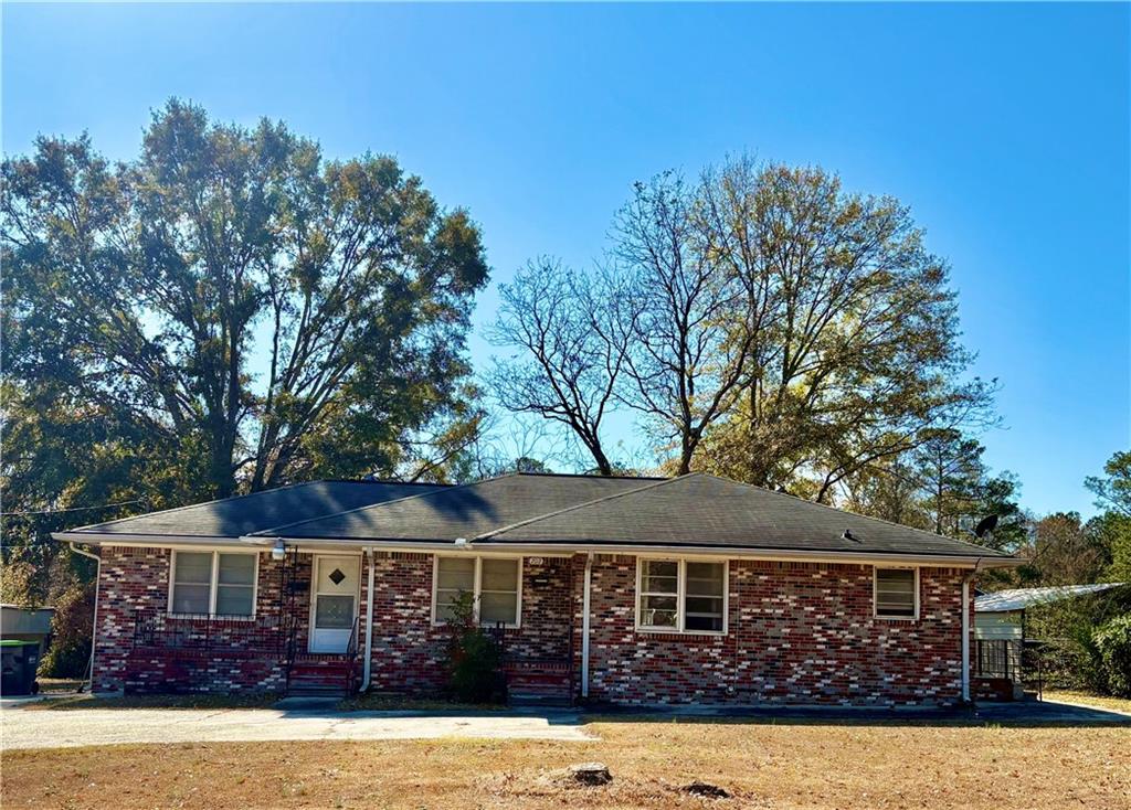 707 Old Powder Springs Road Southwest Mableton, GA 30126 - Photo 1 of 1 a front view of a house with garden