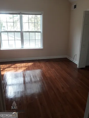 a view of an empty room and wooden floor