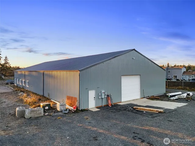 a backyard of a house with barbeque oven and outdoor seating