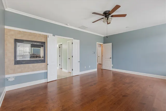 a view of a livingroom with a ceiling fan and window