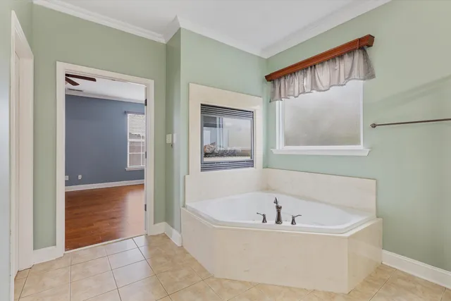 a bathroom with a tub sink and a mirror