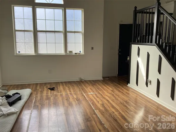 a view of an empty room and wooden floor