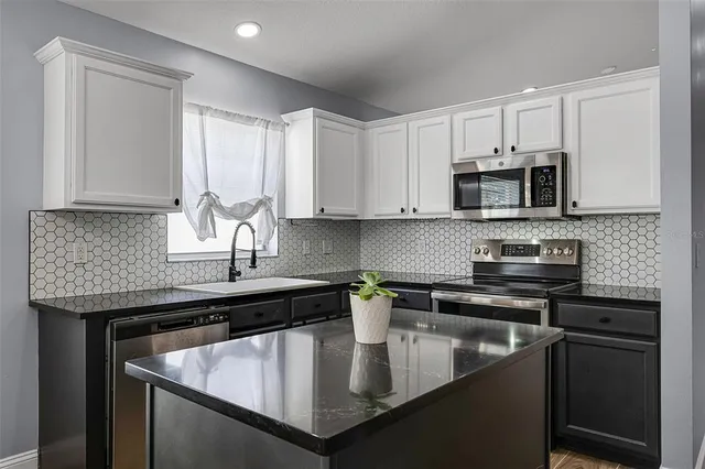 a view of a kitchen with a microwave and a ceiling fan