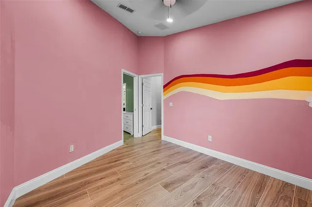 a bathroom with a sink a toilet a mirror and shower