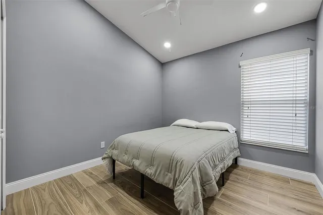 a view of yard with swimming pool and trees in the background