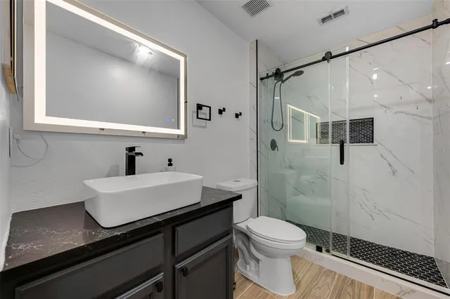 an aerial view of a house with a lake view