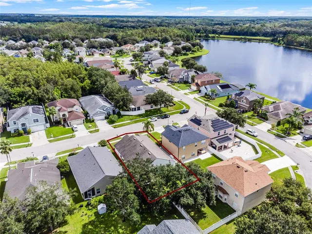 an aerial view of a houses with a yard