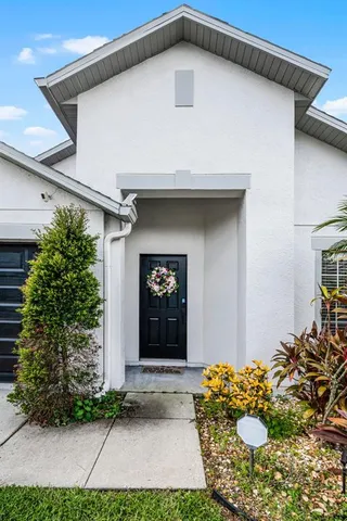 a view of empty room with wooden floor and window