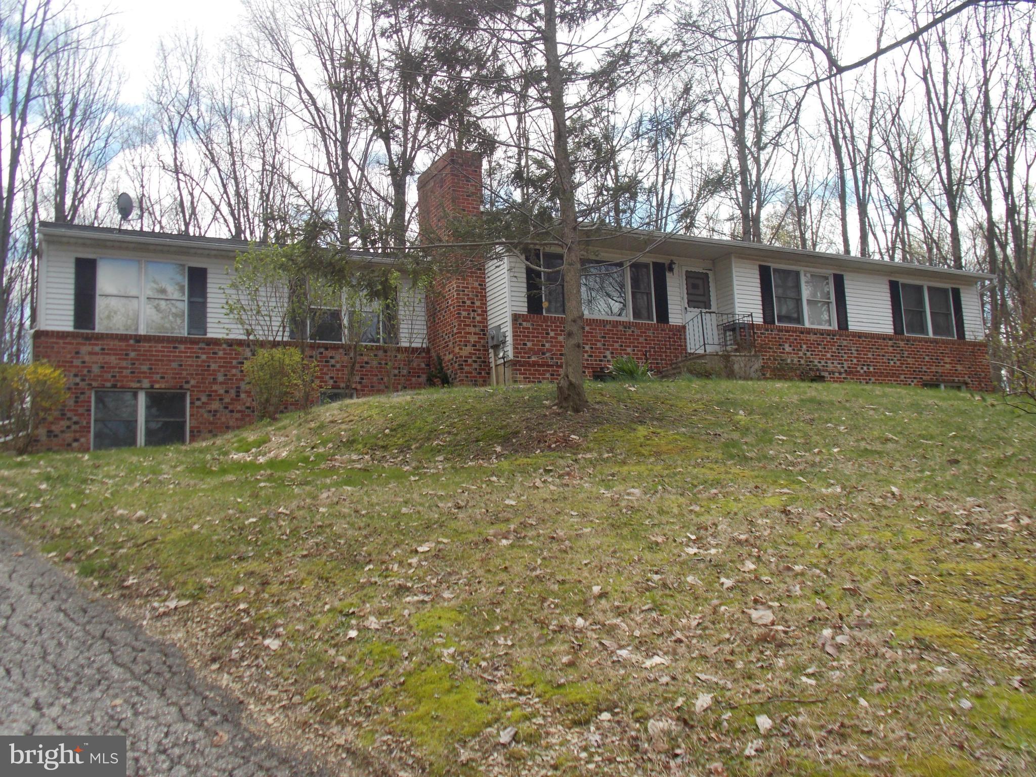 3039 Menges Mill Road Taneytown, MD 21787 - Photo 1 of 25 a view of a yard in front of a house with large tree