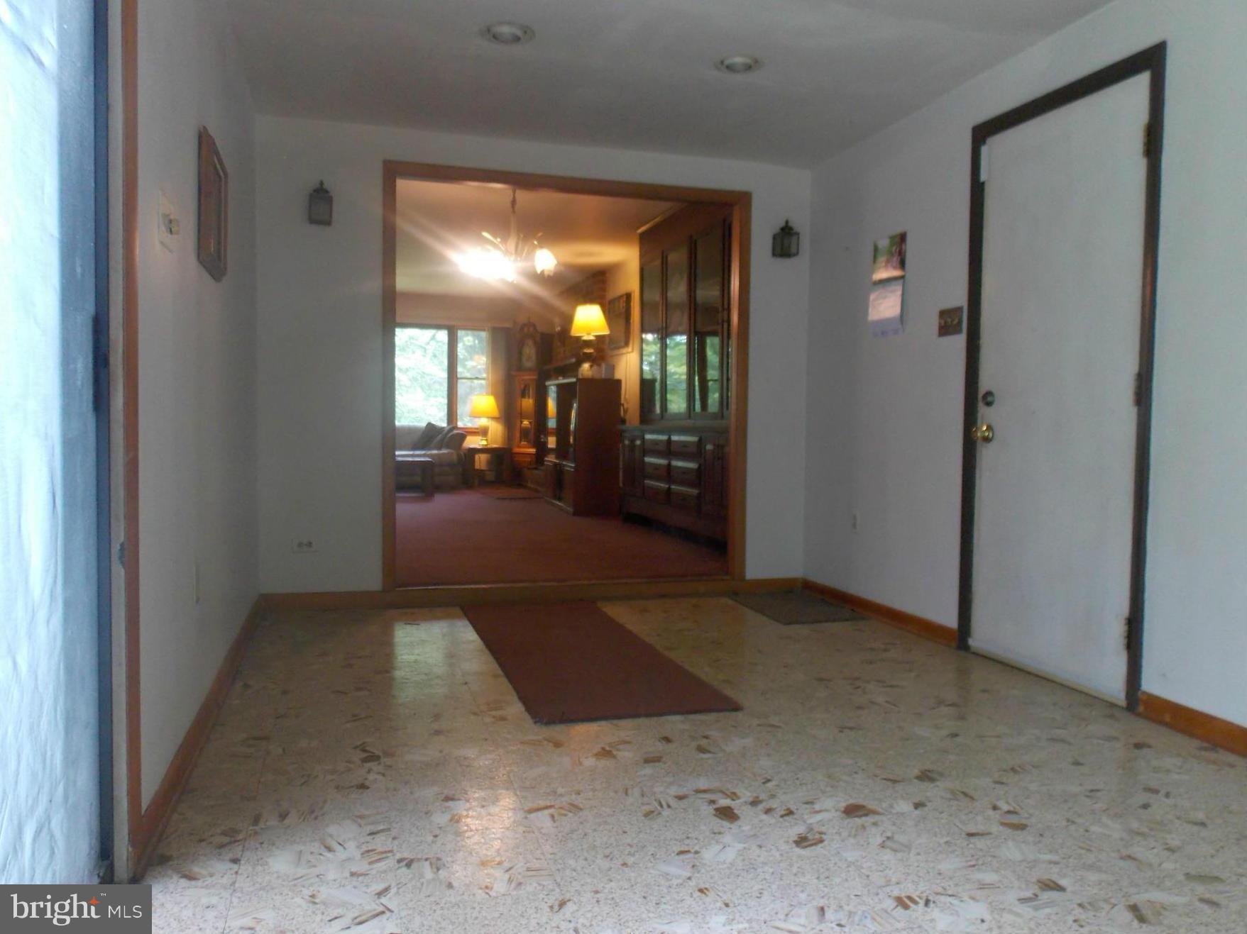 3039 Menges Mill Road Taneytown, MD 21787 - Photo 2 of 25 a view of a hallway with wooden shelves
