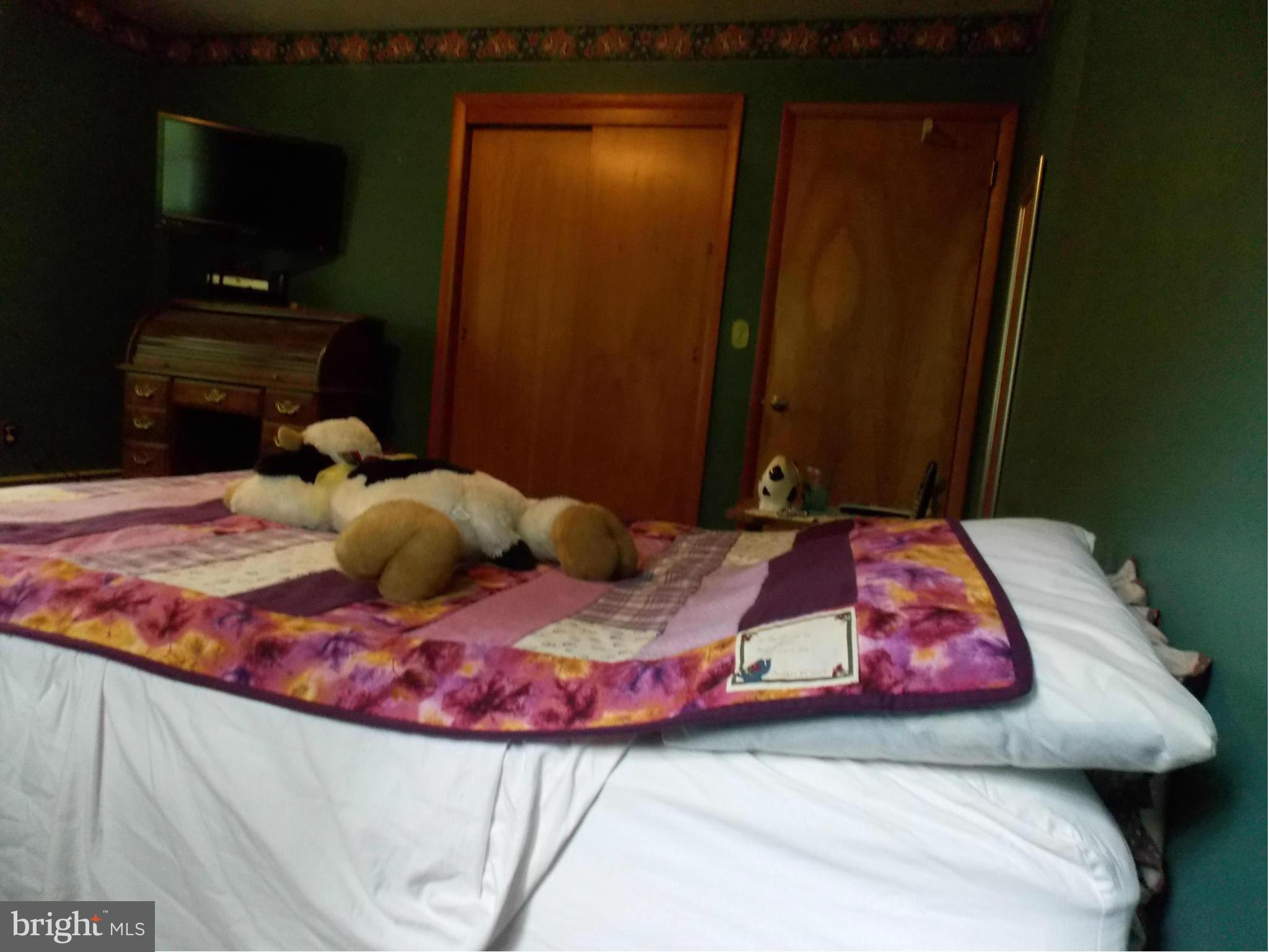 3039 Menges Mill Road Taneytown, MD 21787 - Photo 13 of 25 a bedroom with a bed and teddy bear on bed