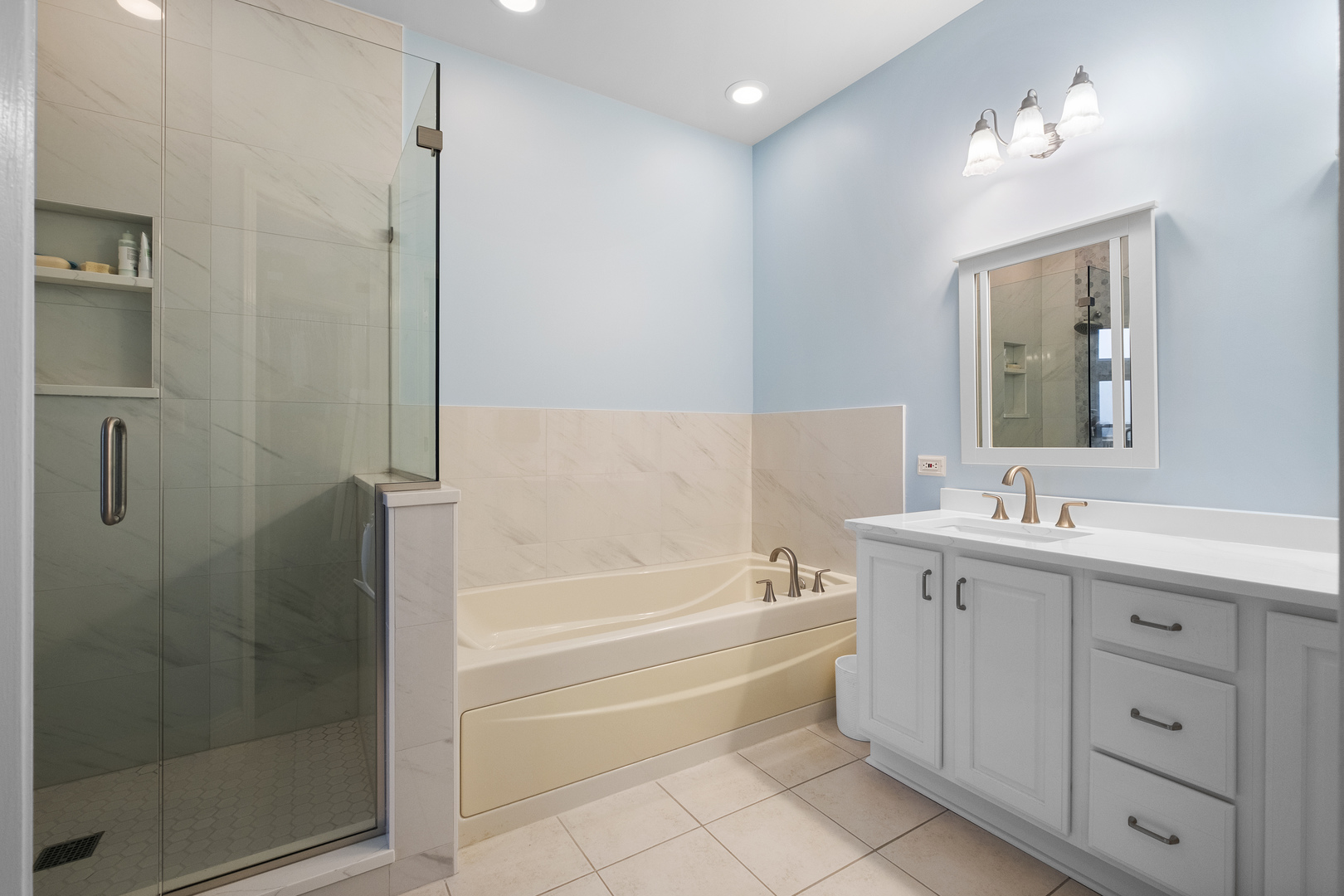 1076 Inverness Drive Antioch, IL 60002 - Photo 17 of 39 a spacious bathroom with a tub sink shower and mirror