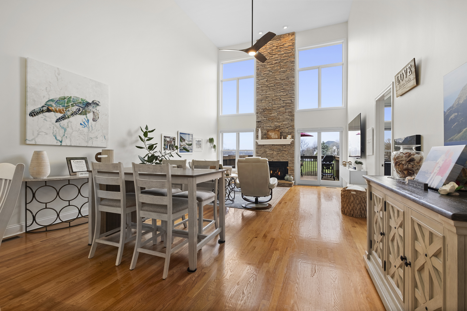1076 Inverness Drive Antioch, IL 60002 - Photo 19 of 39 a dining room with furniture a chandelier and wooden floor