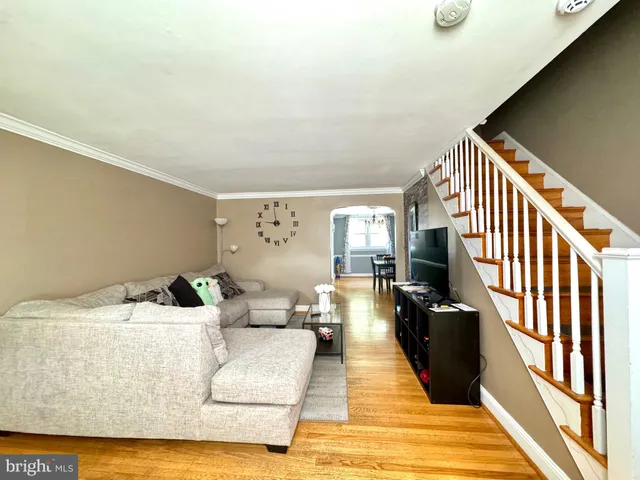 a living room with furniture rug and wooden floor