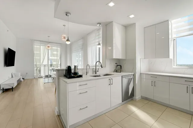 a large white kitchen with a large window