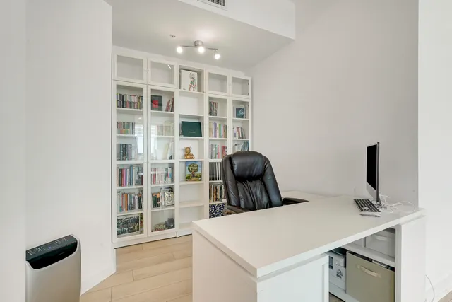 a bathroom with a granite countertop toilet a sink and a mirror