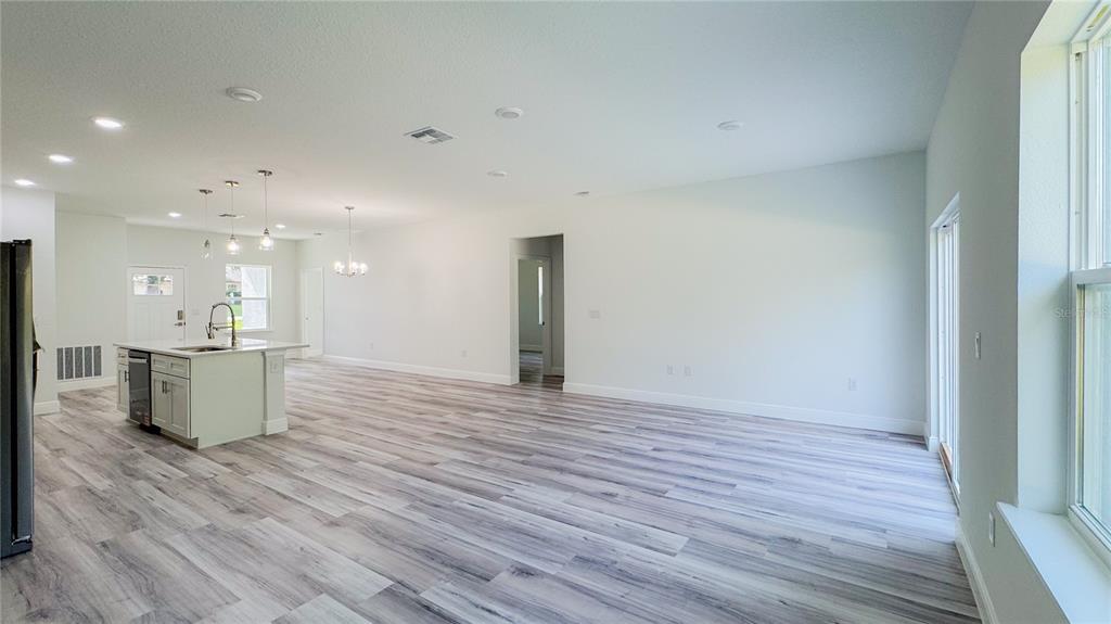15625 Southwest 37th Circle Ocala, FL 34473 - Photo 8 of 27 a view of an empty room with wooden floor
