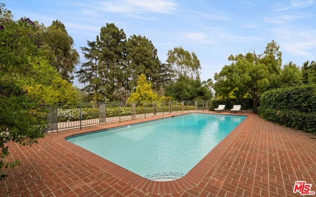 a view of a swimming pool with an outdoor space and seating area